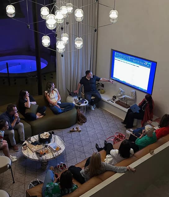 Justin Kabbani leading an Exec AI Residency session for a small group around a screen