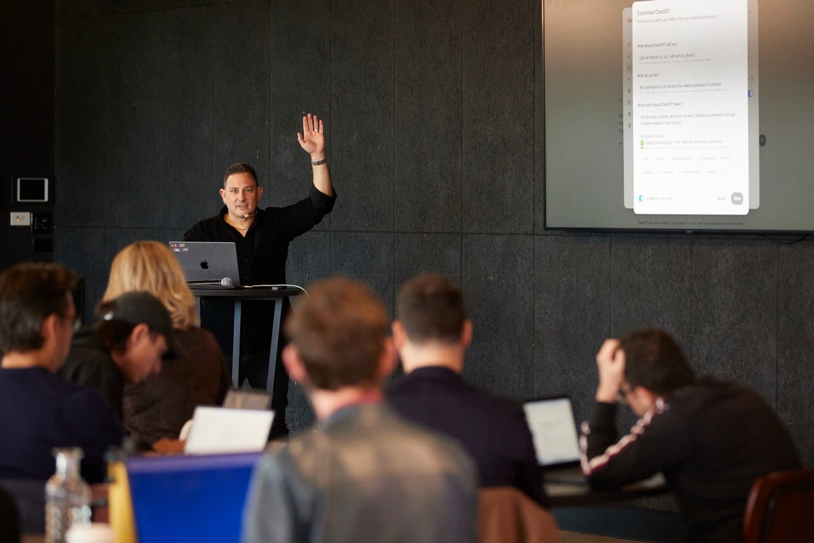 Justin Kabbani teaching a hands-on AI workshop with participants working on laptops
